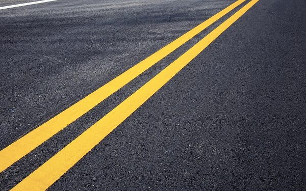 Traffic line of yellow on street with texture background.